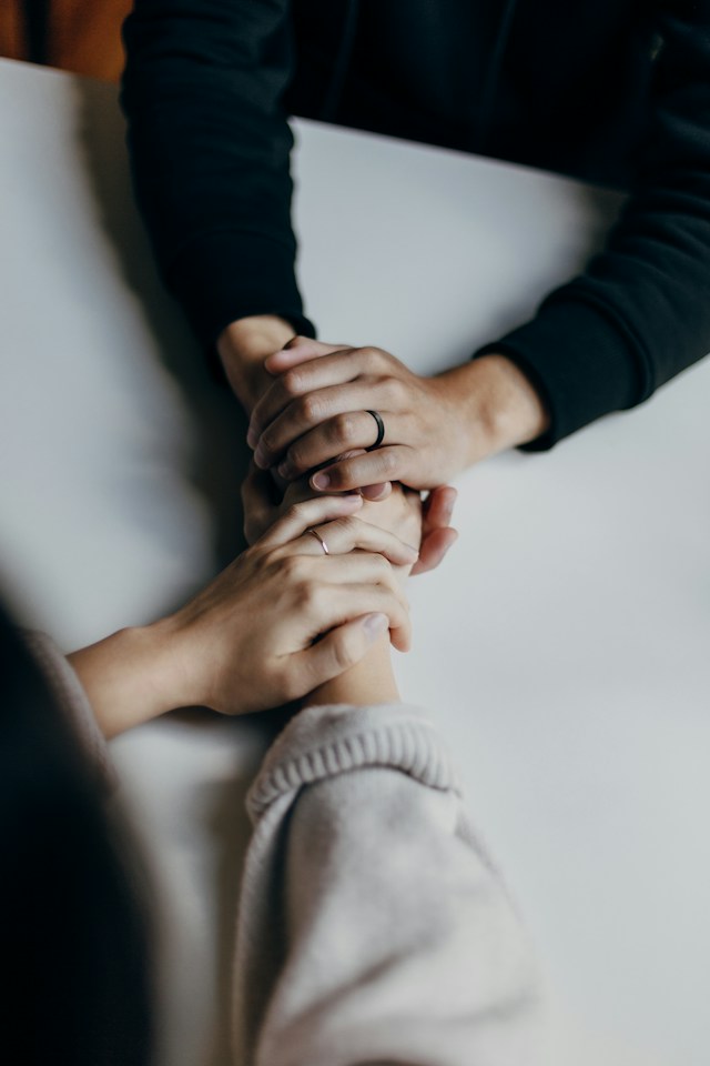 hands holding each other in comfort