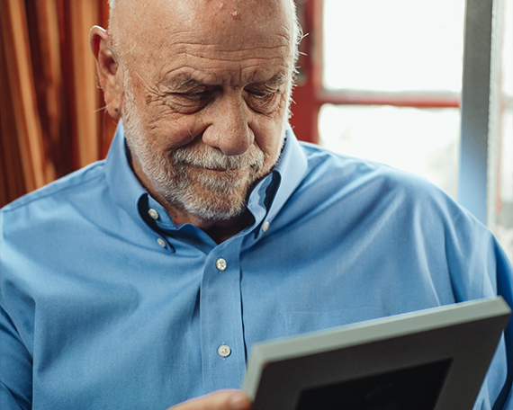 old resident looking at frame