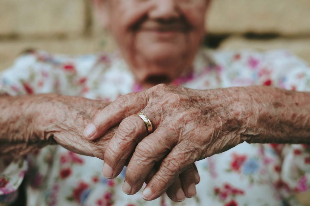 old lady holding hands together
