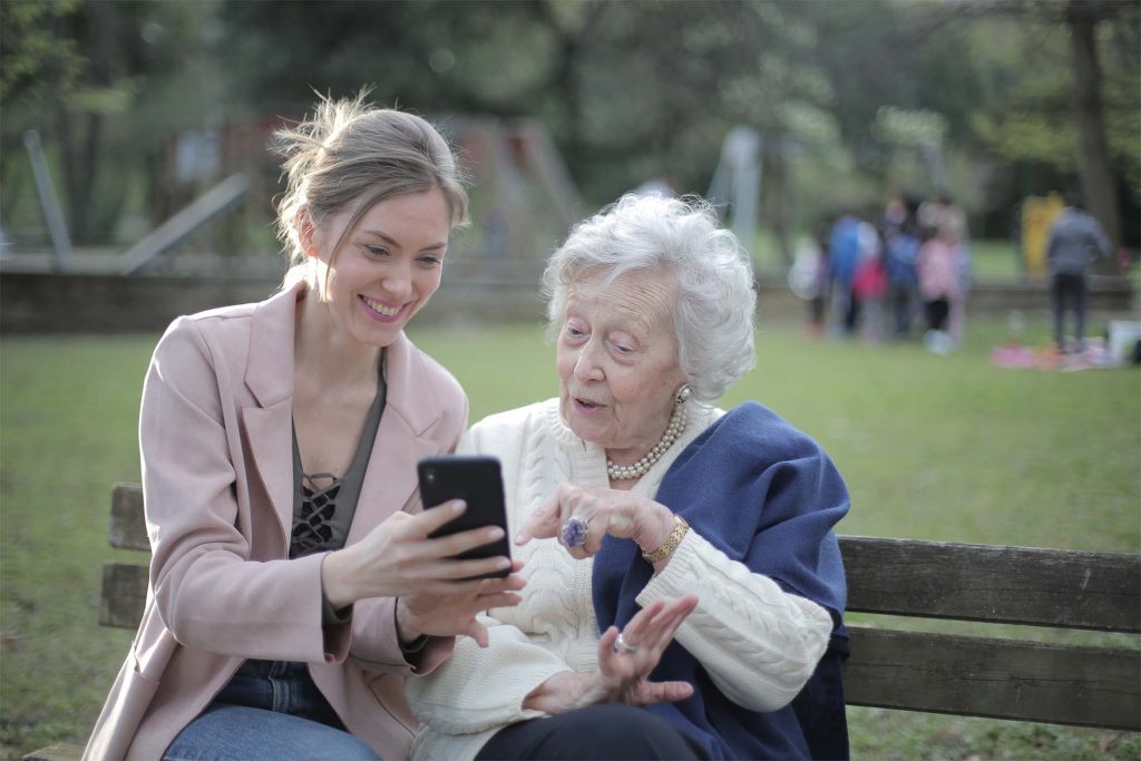 lady helping resident with a phone