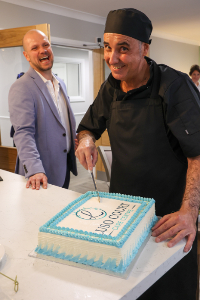 Chef cutting a Lusso Court Care Home Cake